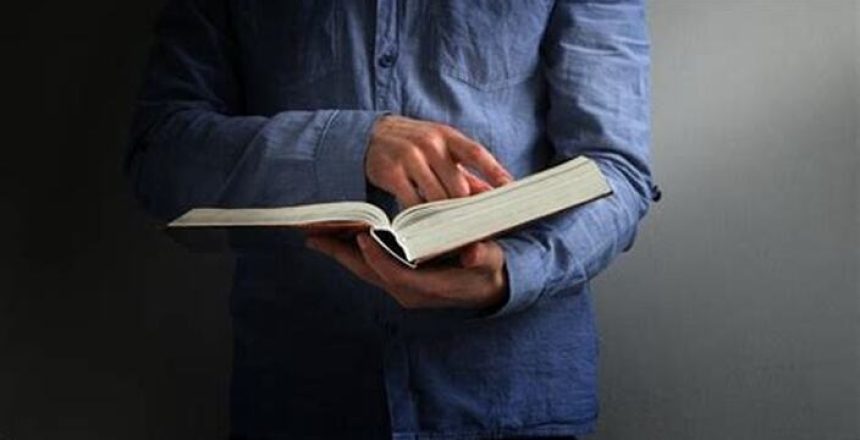 Man pointing at Bible